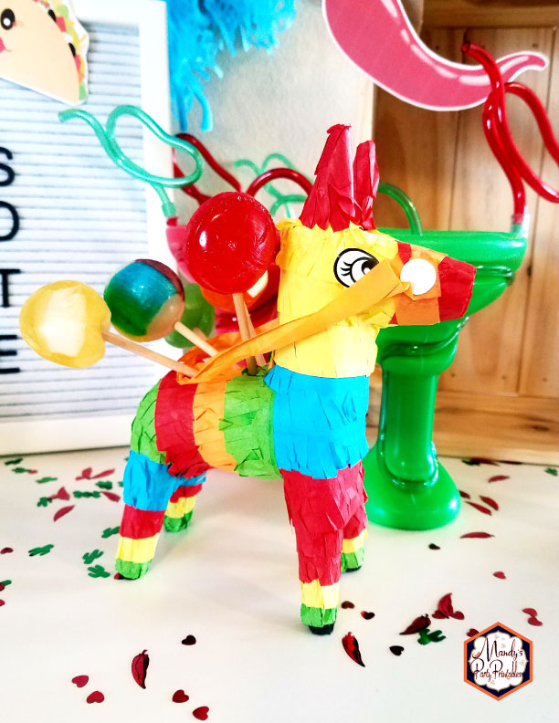 Mini Donkey Pinata holding lollipops from a Taco Bout Love Valentine Taco Party | Mandy's Party Printables #valentineparty #tacoparty #tacoboutlove #ilovetacos #MPP #fiesta
