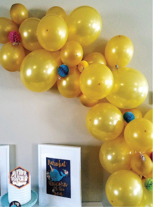 Gold balloon arch with narwhal lollipops and honeycombs | Mandy's Party Printables | A Guide to Half-E Homemaking